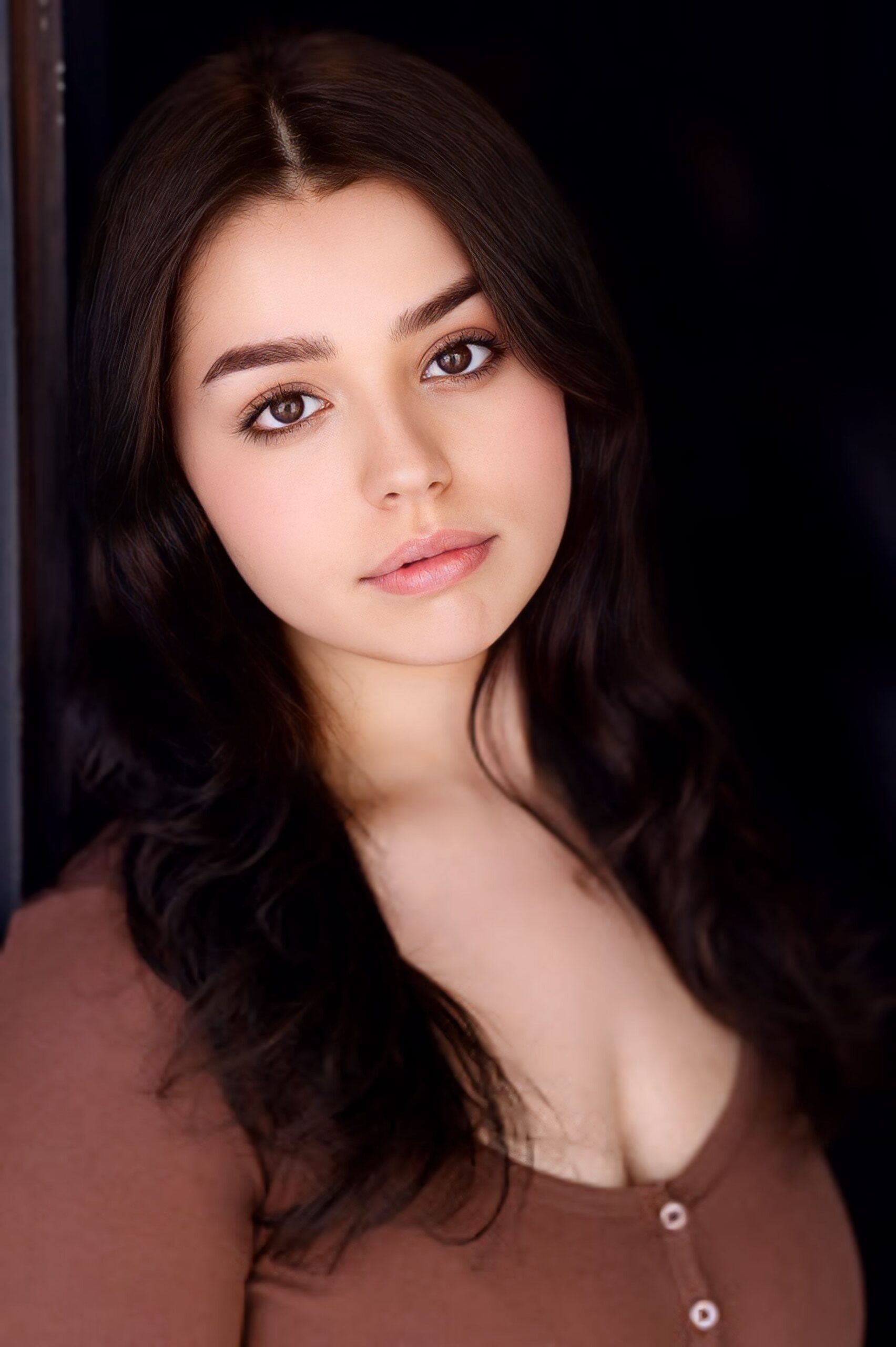 headshot of a young woman with long, dark hair